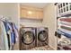 Convenient laundry room with washer, dryer, storage cabinets, and ample space for sorting and folding at 1936 S Mariposa Rd, Apache Junction, AZ 85119