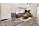 Comfortable living room featuring a modern ceiling fan, sectional sofa, and grey wood-look floors at 1936 S Mariposa Rd, Apache Junction, AZ 85119