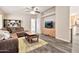 Cozy living room featuring an entertainment center, sectional sofa, and grey wood-look floors at 1936 S Mariposa Rd, Apache Junction, AZ 85119