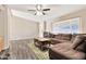 Inviting living room featuring a sectional sofa, grey wood-look floors, and ample natural light at 1936 S Mariposa Rd, Apache Junction, AZ 85119