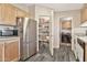 Well-stocked pantry with shelving, paired with stainless appliances and wood-look floors at 1936 S Mariposa Rd, Apache Junction, AZ 85119