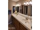 Bathroom features a dual sink vanity with a large mirror and decorative lighting fixtures at 205 N 74Th St # 234, Mesa, AZ 85207