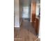 Inviting hallway with light wood flooring, leading to the front door and other rooms at 205 N 74Th St # 234, Mesa, AZ 85207