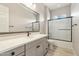 Stylish bathroom featuring a dual sink vanity, sleek fixtures, and a glass-enclosed shower at 2081 E Aquarius Pl, Chandler, AZ 85249