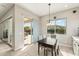 Bright breakfast nook with backyard pool view and a modern pendant light fixture at 2081 E Aquarius Pl, Chandler, AZ 85249