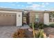 Close-up of home's entryway featuring brick accents and desert landscaping at 2081 E Aquarius Pl, Chandler, AZ 85249