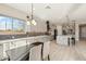 Bright kitchen with stainless appliances, a tile backsplash, and views of the backyard at 2081 E Aquarius Pl, Chandler, AZ 85249