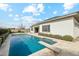 Backyard featuring a diving board, a tiled pool, and a view of the home's stucco exterior at 2081 E Aquarius Pl, Chandler, AZ 85249