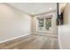 Empty room featuring hardwood floors, neutral paint and baseboards, and a large window at 2081 E Aquarius Pl, Chandler, AZ 85249