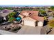 Aerial view of the home with a three-car garage, patio area, tile roof and desert landscaping at 21500 N 262Nd Ln, Buckeye, AZ 85396