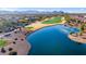 Aerial view of community lake, golf course, and surrounding homes at 21500 N 262Nd Ln, Buckeye, AZ 85396