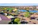 Back aerial showing patio with awning, and view of community pond and common areas with walking trails at 21500 N 262Nd Ln, Buckeye, AZ 85396