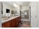 Bathroom featuring double sinks and a glass enclosed shower with neutral decor at 21500 N 262Nd Ln, Buckeye, AZ 85396