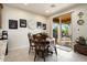 Charming dining area with wooden table and chairs, sliding doors to the outdoor patio at 21500 N 262Nd Ln, Buckeye, AZ 85396