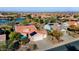 Aerial view of home showing the tile roof, two-car garage, desert landscaping, and proximity to the community lake at 21500 N 262Nd Ln, Buckeye, AZ 85396