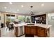 A kitchen with stainless steel appliances and granite countertops adjoins a dining area with sliding glass doors at 21500 N 262Nd Ln, Buckeye, AZ 85396