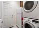 Practical laundry room featuring a stacked washer and dryer, with storage at 21500 N 262Nd Ln, Buckeye, AZ 85396