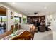 Open floor plan with a dining table, a comfortable seating area, and a built-in entertainment center at 21500 N 262Nd Ln, Buckeye, AZ 85396