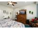 Comfortable main bedroom featuring a dresser with a TV, sitting chair, and a doorway at 21500 N 262Nd Ln, Buckeye, AZ 85396