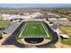 Aerial view of school athletic field, track, bleachers, and parking on a sunny day at 22317 N 39Th Run, Phoenix, AZ 85050