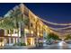 Commercial building exterior with storefronts and outdoor seating at night with decorative street lights at 22317 N 39Th Run, Phoenix, AZ 85050