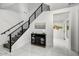 Bright entryway with modern staircase, console table, mirror, and gold wall art at 22317 N 39Th Run, Phoenix, AZ 85050