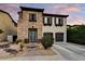 Inviting two-story home with a stone facade, dark shutters, and a well-manicured lawn at 22317 N 39Th Run, Phoenix, AZ 85050