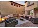 Inviting outdoor living space with comfortable seating, a water feature, and lush landscaping at 22317 N 39Th Run, Phoenix, AZ 85050