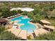 Beautiful community pool area with lush landscaping, covered seating, and a hot tub at 22317 N 39Th Run, Phoenix, AZ 85050