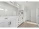 Bathroom featuring dual sinks with white cabinetry and a large mirror at 22679 E Estrella Rd, Queen Creek, AZ 85142