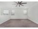 Large bedroom with a fan and carpet and three large windows providing natural light at 22679 E Estrella Rd, Queen Creek, AZ 85142