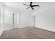 Bright bedroom with carpet, ceiling fan, and white walls at 22679 E Estrella Rd, Queen Creek, AZ 85142