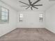 Bedroom with neutral carpet and a ceiling fan and three large windows offering beautiful outdoor views at 22679 E Estrella Rd, Queen Creek, AZ 85142