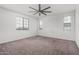 Bedroom with neutral carpet and a ceiling fan and multiple windows offering beautiful outdoor views at 22679 E Estrella Rd, Queen Creek, AZ 85142