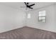 Bright bedroom featuring plush carpet, ceiling fan and lots of natural light at 22679 E Estrella Rd, Queen Creek, AZ 85142