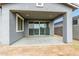 Covered patio with concrete floor and stucco exterior, featuring sliding glass doors to the home's interior at 22679 E Estrella Rd, Queen Creek, AZ 85142