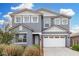 Two-story home with a gray exterior, white trim, a two-car garage, and desert landscaping under a partly cloudy blue sky at 22679 E Estrella Rd, Queen Creek, AZ 85142