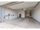 Spacious garage with ample storage space, featuring an automatic door, concrete floors, and bright lighting at 22679 E Estrella Rd, Queen Creek, AZ 85142