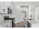 Kitchen featuring stainless steel appliances, white cabinets, quartz countertops, and a center island with a sink at 22679 E Estrella Rd, Queen Creek, AZ 85142