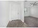 Bright room with tile and carpet flooring, a ceiling fan, a window, and a white door and trim at 22679 E Estrella Rd, Queen Creek, AZ 85142