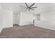 Bright open living area with neutral walls and carpet and a large entry way at 22679 E Estrella Rd, Queen Creek, AZ 85142