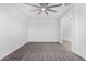 Spacious room with neutral carpet flooring, a ceiling fan, and a view into a bright hallway at 22679 E Estrella Rd, Queen Creek, AZ 85142