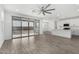 Bright open floor plan featuring a kitchen with an island and a living room with tile flooring and a ceiling fan at 22679 E Estrella Rd, Queen Creek, AZ 85142