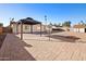 View of the home's backyard with pavers, gazebo, mature trees and a shed at 2305 S Orange --, Mesa, AZ 85210