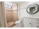 Bathroom featuring a tiled shower, white wooden plank wall, and a modern sink at 2305 S Orange --, Mesa, AZ 85210