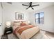 A cozy bedroom featuring soft, neutral tones, decorative rug, and a modern ceiling fan at 2305 S Orange --, Mesa, AZ 85210