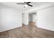 Bedroom with modern ceiling fan, hardwood floors, and an open doorway to another room at 2305 S Orange --, Mesa, AZ 85210