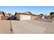 View of the home's exterior, featuring desert landscaping and a two-car garage at 2305 S Orange --, Mesa, AZ 85210