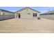 Large backyard with dirt, block fence, and new construction at 23957 W Papago St, Buckeye, AZ 85326