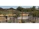 Community area in new home development features green space, walking path, metal fence, drought-resistant vegetation, and modern street lights at 23957 W Papago St, Buckeye, AZ 85326